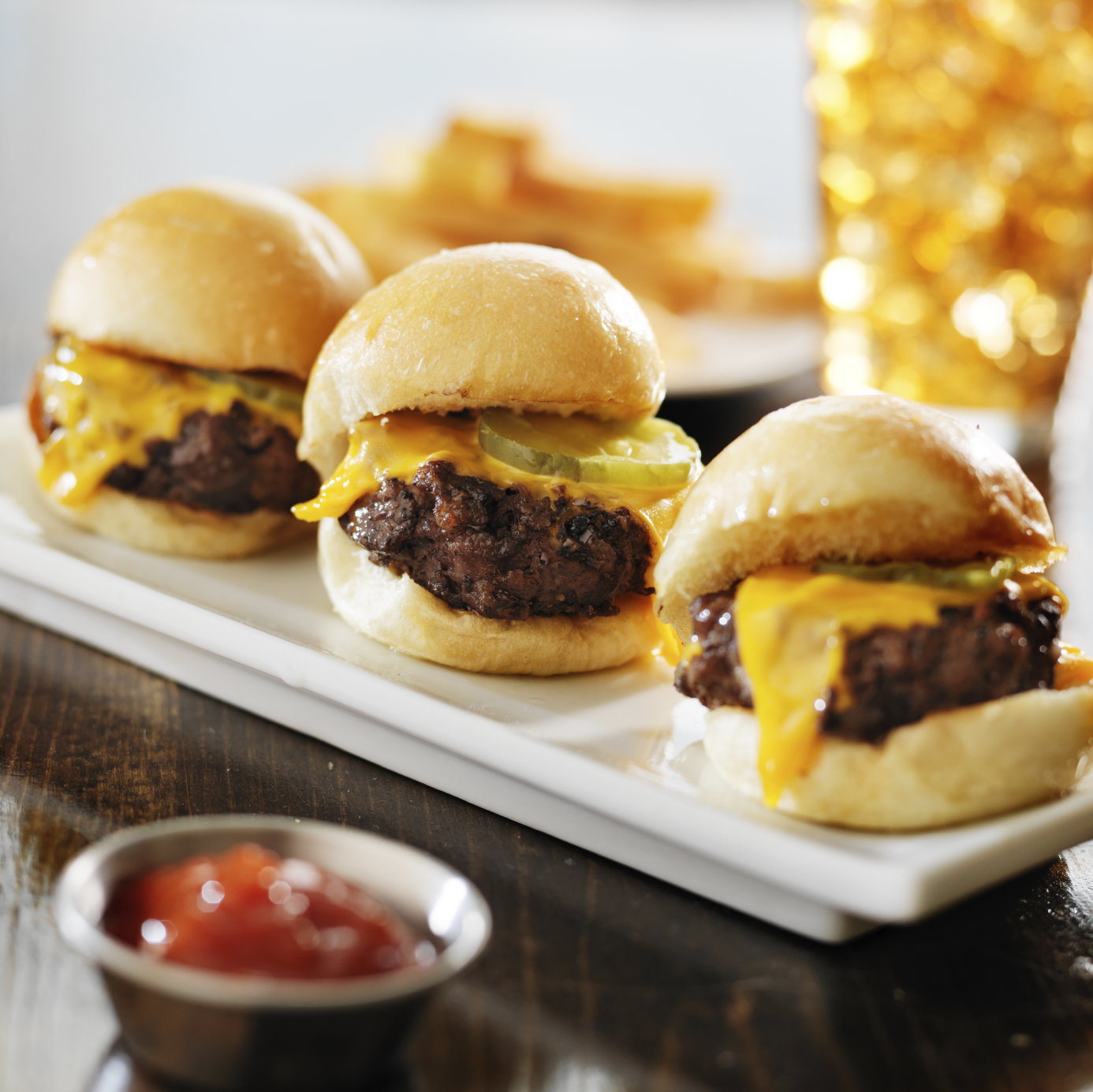 burger sliders with melted cheese and pickle